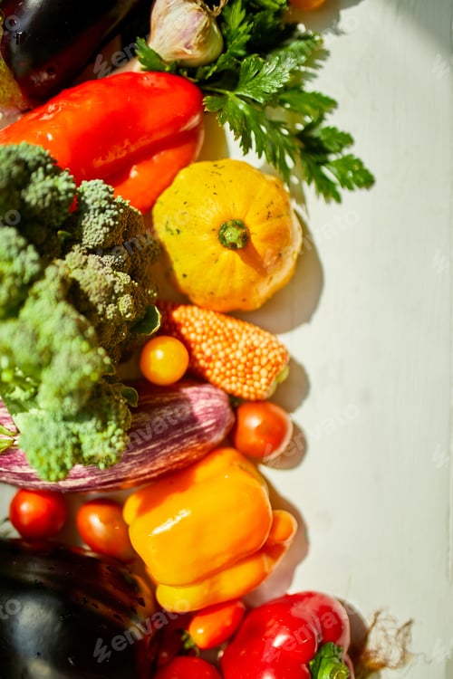 Preview: Top view assorted fresh organic vegetables on table in the kitchen