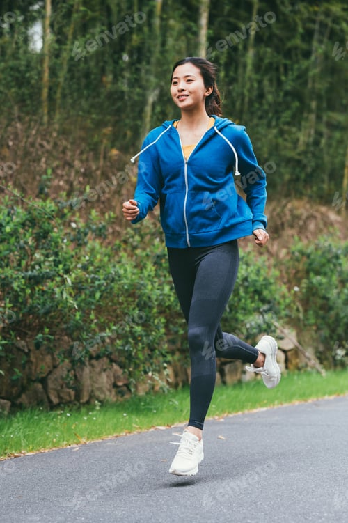 Preview: Young Asian woman running in country road