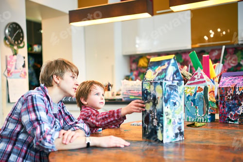 Preview: Cute happy little boy and teacher drawing in artist class