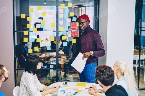 Preview: professional man coach leading brainstorm session with diverse group of students