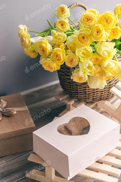 Preview: Basket with yellow flowers and gift box, copy space.