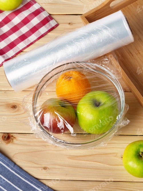 Preview: Bowl of fresh fruit in a glass bowl covered with cling film