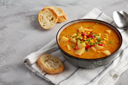 Preview: Homemade Corn Chowder in a Bowl, side view. Copy space.