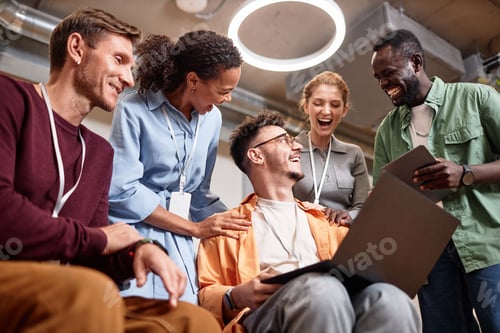 Preview: Successful business team working with project together using laptop