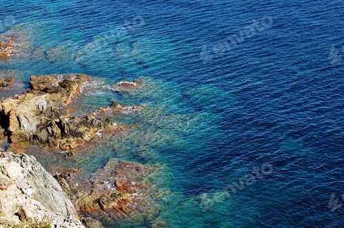 Preview: Beautiful clear, turquoise sea water and rocky coast