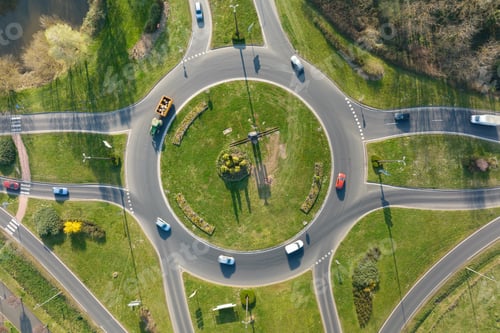 Preview: Aerial view of road roundabout intersection with moving heavy traffic.
