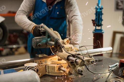 Preview: Worker working with a circular grinder on a metal with sparks