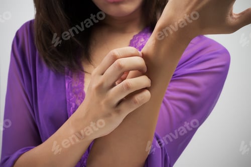 Adult Scratching Arm in Purple Robe at Home