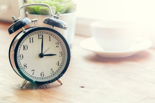 Preview: Morning sun. Alarm clock on a beautiful background