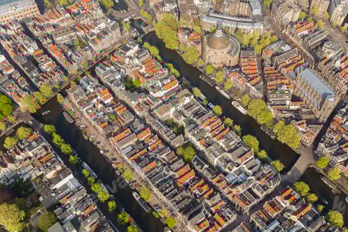 Preview: Aerial view of a city with rows of houses channels and bridges.