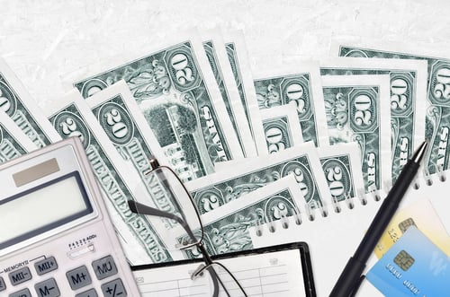 Preview: business flatlay layout of 20 dollar bills and calculator