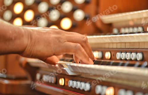 Preview: An unrecognizable diverse black musician plays the organ at a Sunday morning worship service