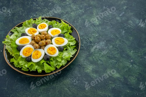 Preview: front view boiled sliced eggs with olives and green salad on dark blue background food health tea