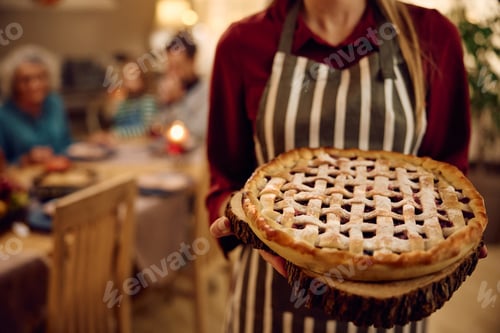 Preview: Close up of woman with baked Thanksgiving pie.