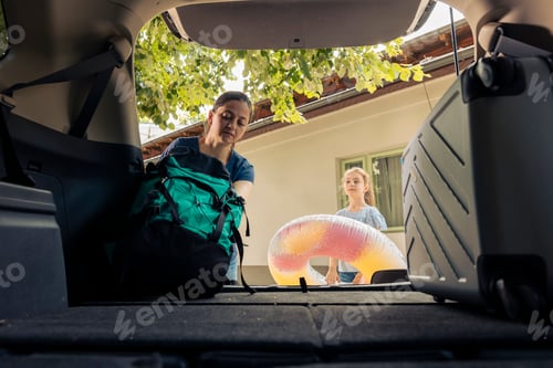 Preview: Mother and little girl loading baggage