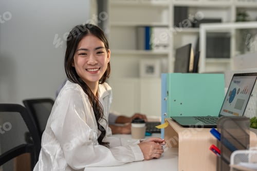 Preview: Portrait of Asian beautiful businesswoman smiling while working in office.
