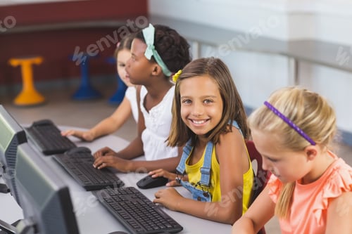Preview: Schoolgirls using computer in classroom