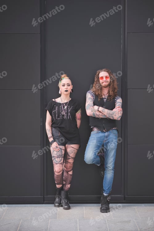 Preview: Portrait of punk hippy couple leaning against wall