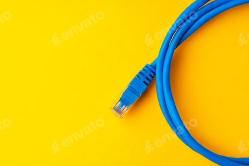 Preview: Network cable on yellow background studio shot