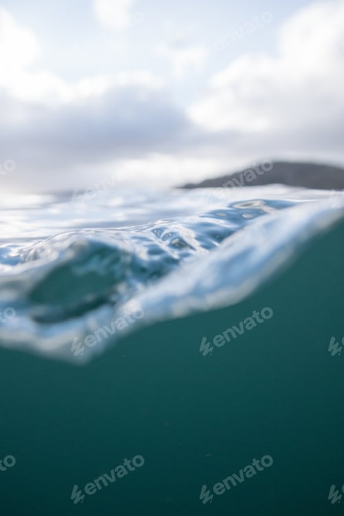 Ocean Water Surface With Cloudy Skies Above
