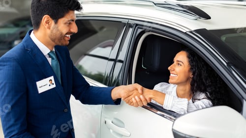 Preview: Happy business woman buying new luxury auto in showroom