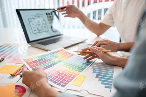 Preview: Two creative graphic designer team working on color selection and drawing on graphic tablet