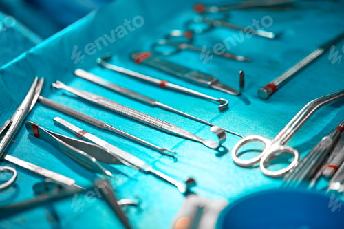 Preview: Sterile instruments on the operating table, blue light, real operating room.