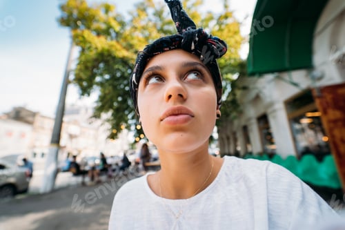 Preview: Portrait of positive cheerful girl looking up imagining a plan