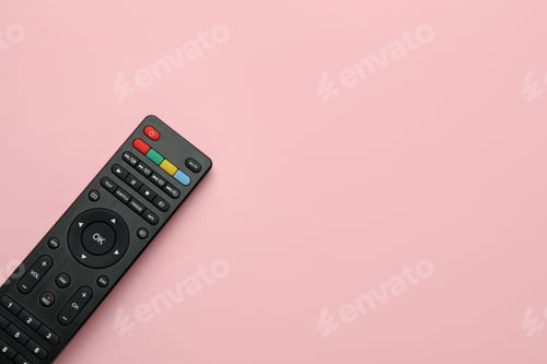 Preview: Remote control on pink background, top view. Space for text