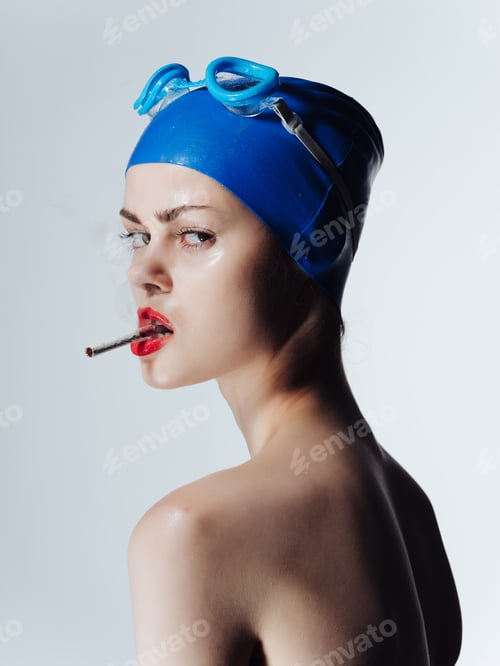 Preview: athlete in swimming goggles smokes a cigarette isolated background