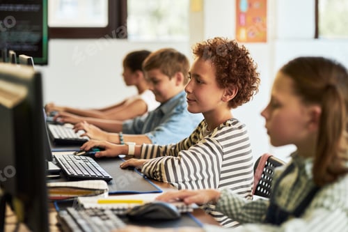 Preview: Group of Preteen Children Using Desktop Computers during Coding Lesson