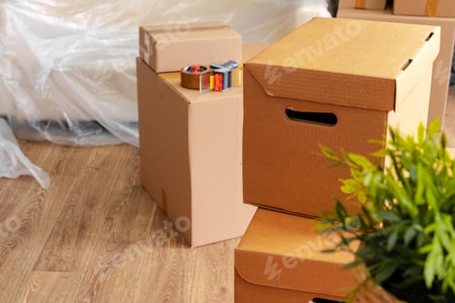 Preview: Moving in or moving out concept. Stack of boxes and packed furniture