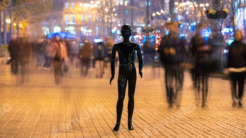 Preview: The mannequin standing on the crowd street. evening time