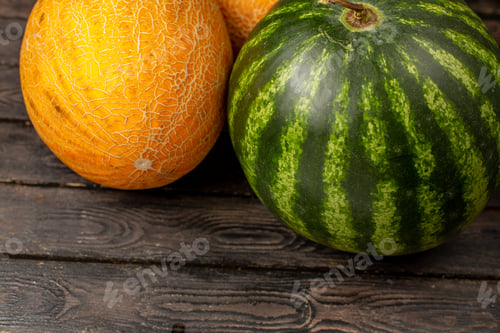Preview: front close view green watermelon whole round formed fresh and juicy fruit with melons on the brown