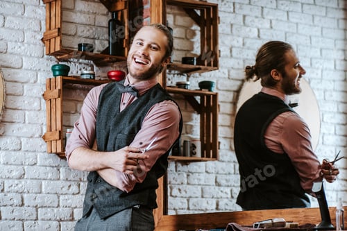 Preview: happy barber laughing while holding scissors