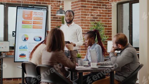 Preview: Man with clipboard explaining financial presentation