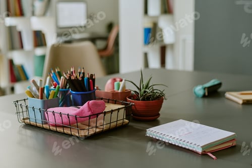 Preview: Organizing School Supplies and Taking Notes on Desk in Classroom Setting
