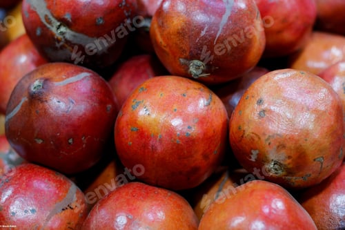 Preview: Closeup shot of a pile of fresh pomegranates at a market