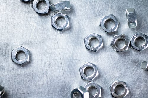 Preview: Working tool. Metal nuts on the table.