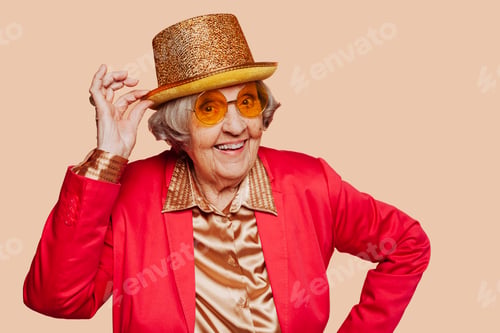 Preview: Funny stylish elderly grandmother posing with hat at studio