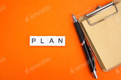 Preview: pen and paper board with the word plan.