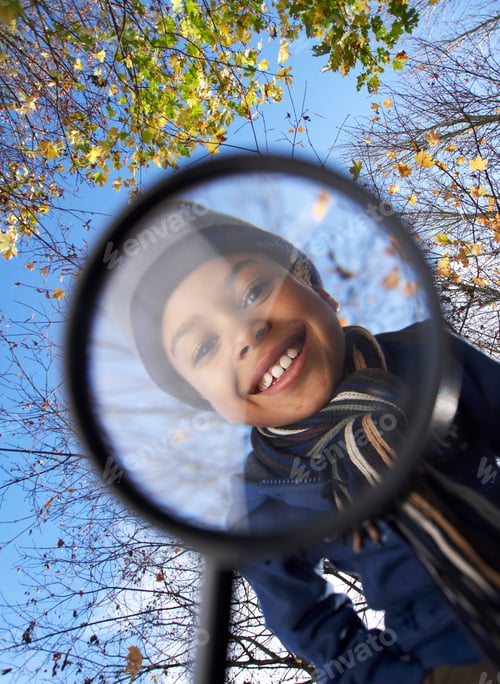 Preview: Boy looking through magnifying glass