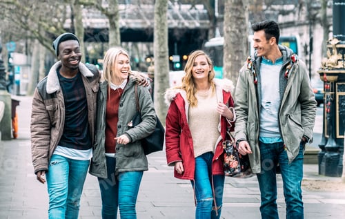 Preview: Multiracial group of millenial friends walking at London city center