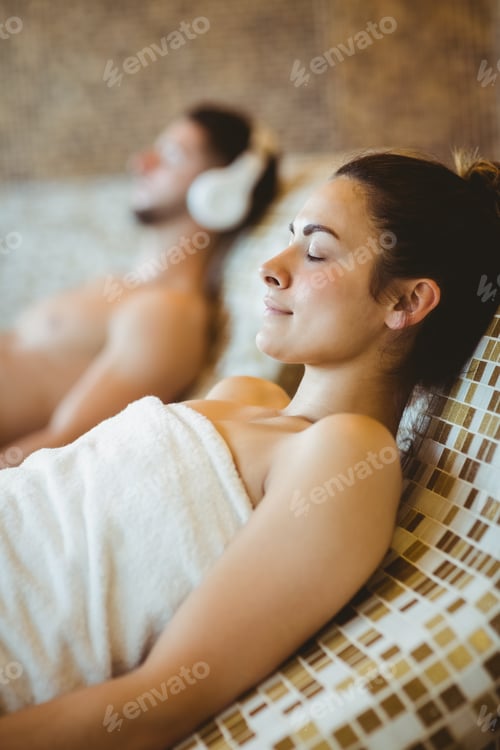 Preview: Man wearing headphones and woman lying down together at the spa