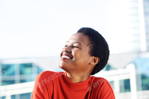 Preview: Close up beautiful young african woman smiling and looking away