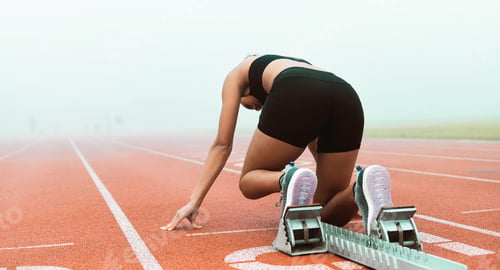 Preview: Rearview shot of an unrecognizable young sportswoman taking her mark on starting blocks