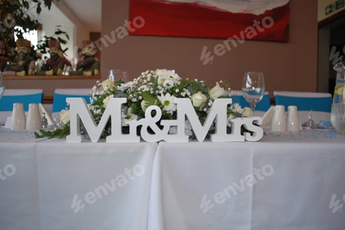 Preview: Me and mrs letters white sign on a wedding table