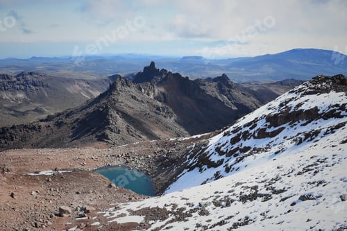 Preview: Scenic view of Lake Michaelson resting under the point of the mount Kenya partially covered by snow