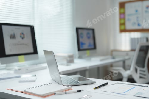 Preview: Modern office desk showing productivity and business charts on screens