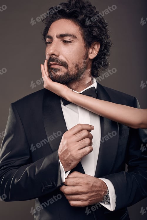 Preview: Fashionable Portrait Of Elegant Sexy Couple In Studio. Brutal Man In Suit With Woman'S Hand